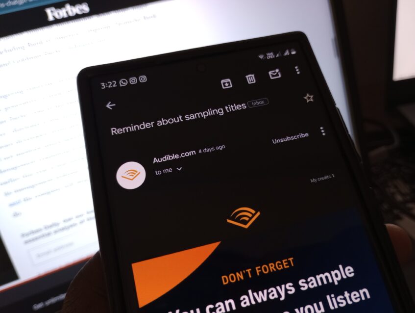 An Android smartphone in the Gmail app, showing an email and the Unsubscribe button.