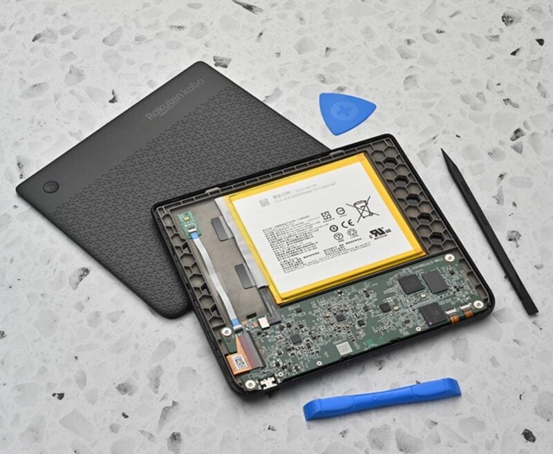 Disassembled Kobo e-reader beside iFixit tools