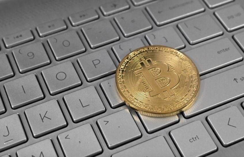 Bitcoin token on a grey keyboard