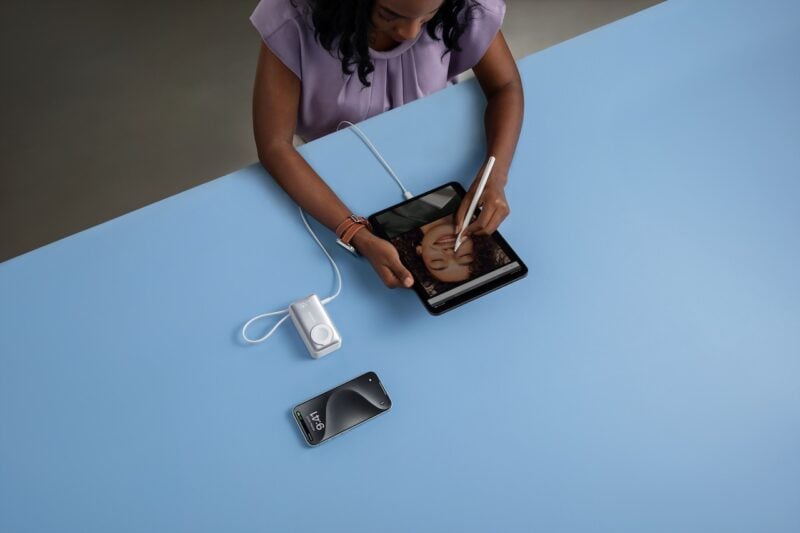 Woman using Anker MagGo power bank for tablet