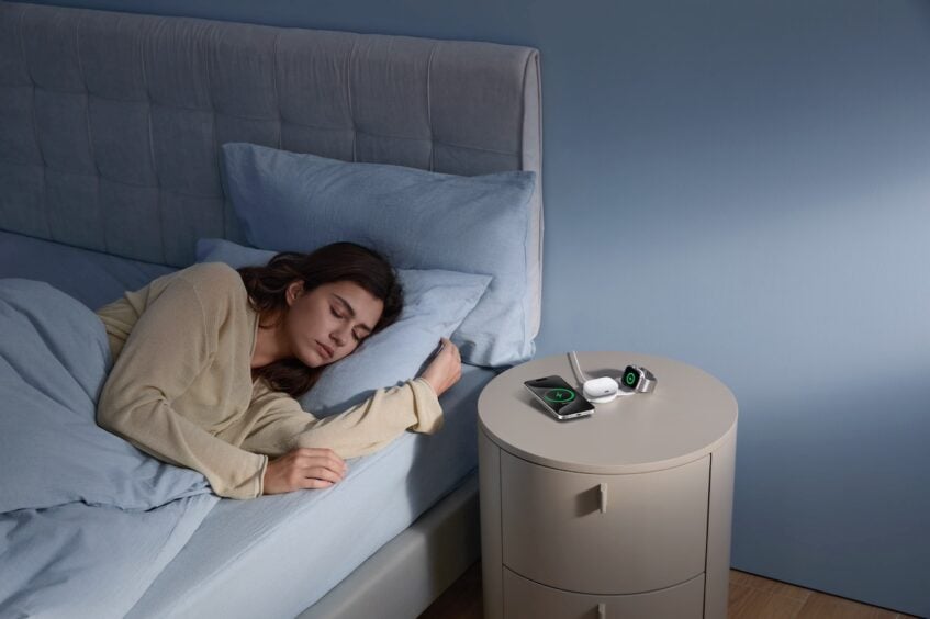 Anker MagGo wireless charging pad on bedside table beside sleeping woman
