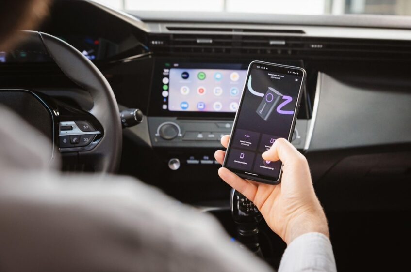 Person using AAWireless companion app inside car