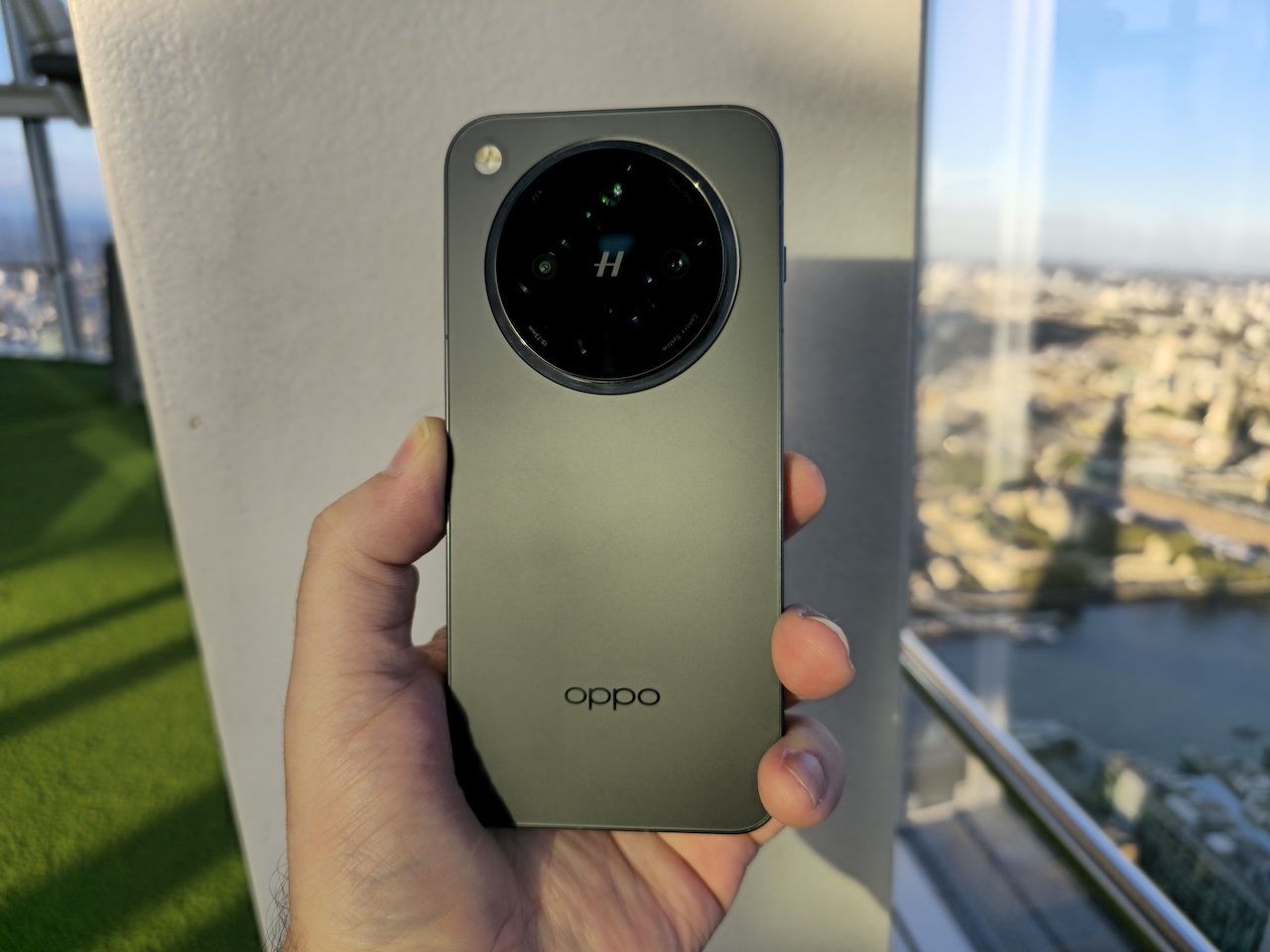 Hand holding Oppo Find X8 with back side facing up