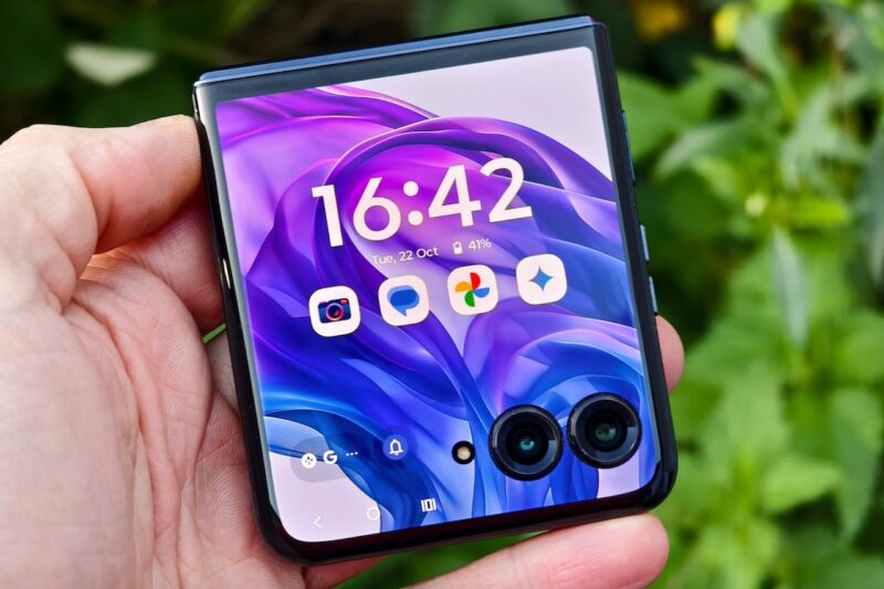 Hand holding Razr+ 2024 with cover display facing up