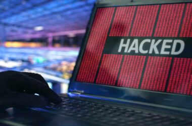 Close up shot of white Hacked text on red background on laptop screen