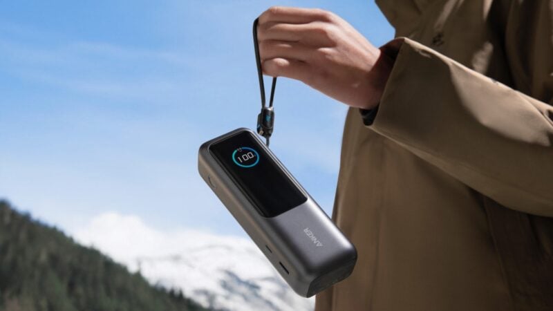 Person dangling Anker 165W power bank by the retractable cable