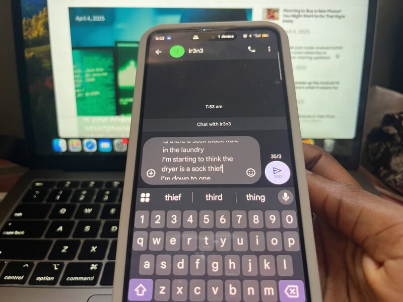 Hand holding phone with Google Messages app open