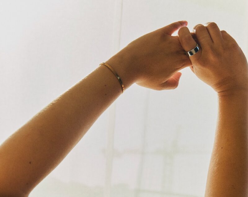 Raised hands with Oura ring on one finger