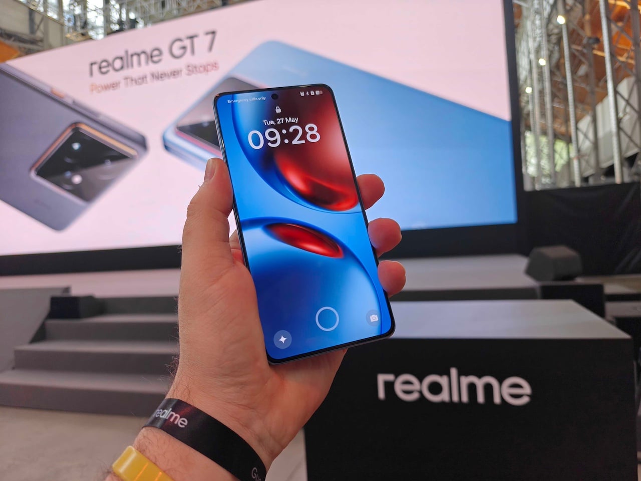 Hand holding Realme GT 7 phone with display visible