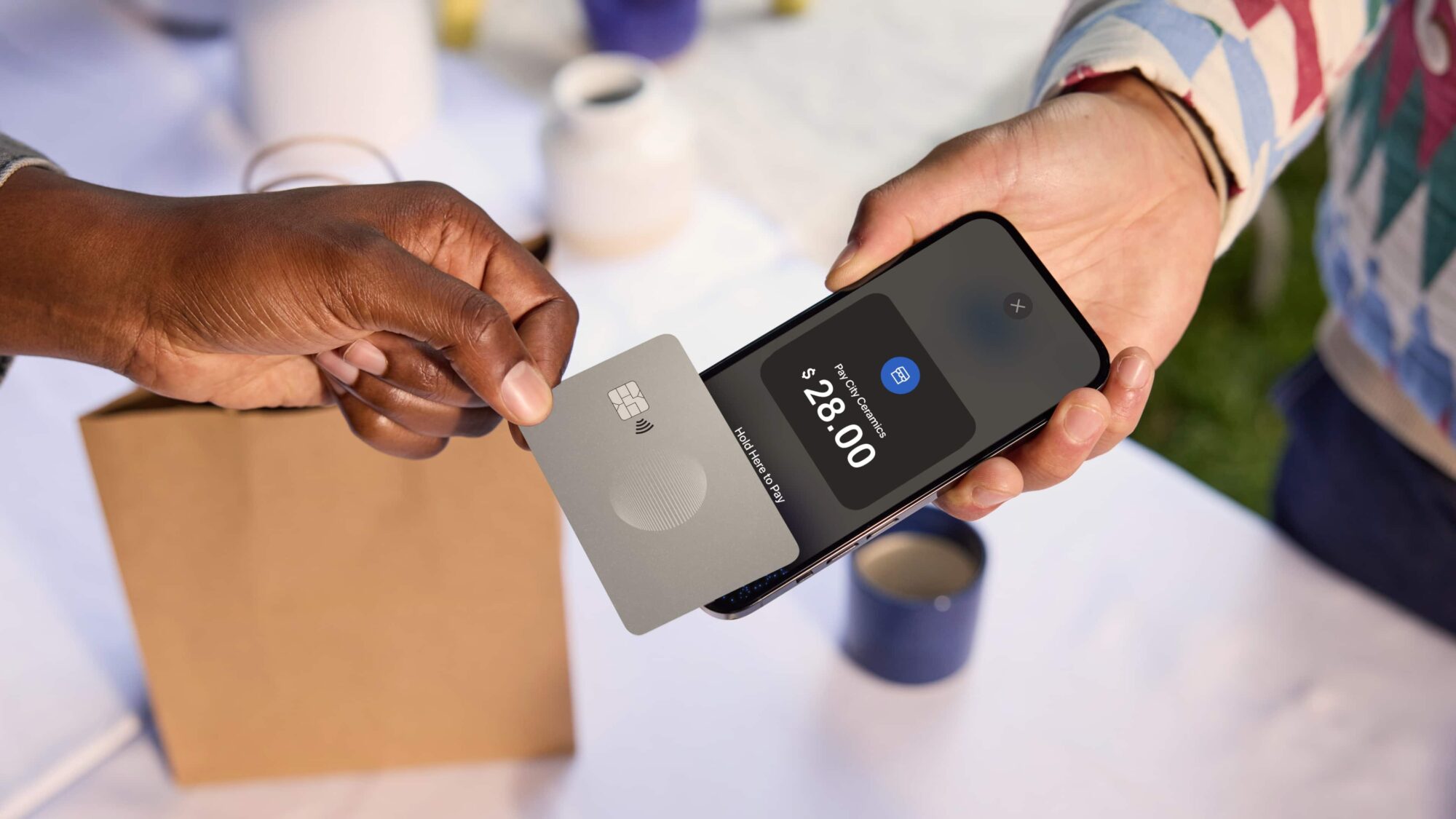 Hand placing card on payment terminal