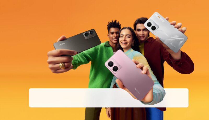 Two men and one woman smiling and holding out Realme P3 phones