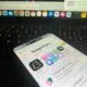 Phone resting on laptop keyboard showing Snapchat Plus perks menu