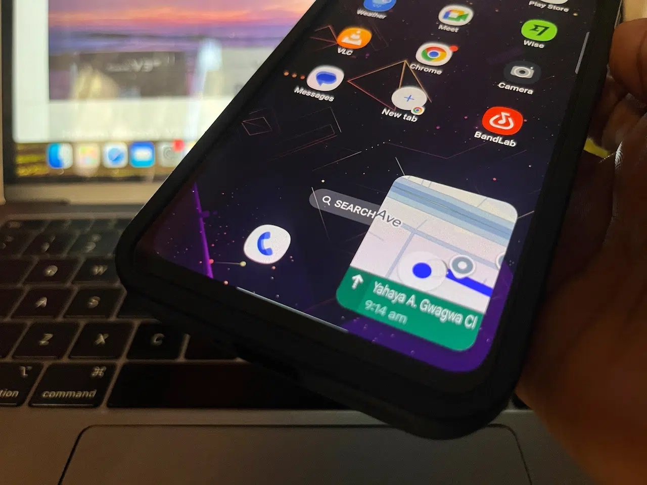 Hand holding phone showing Google Maps Picture-in-Picture navigation screen