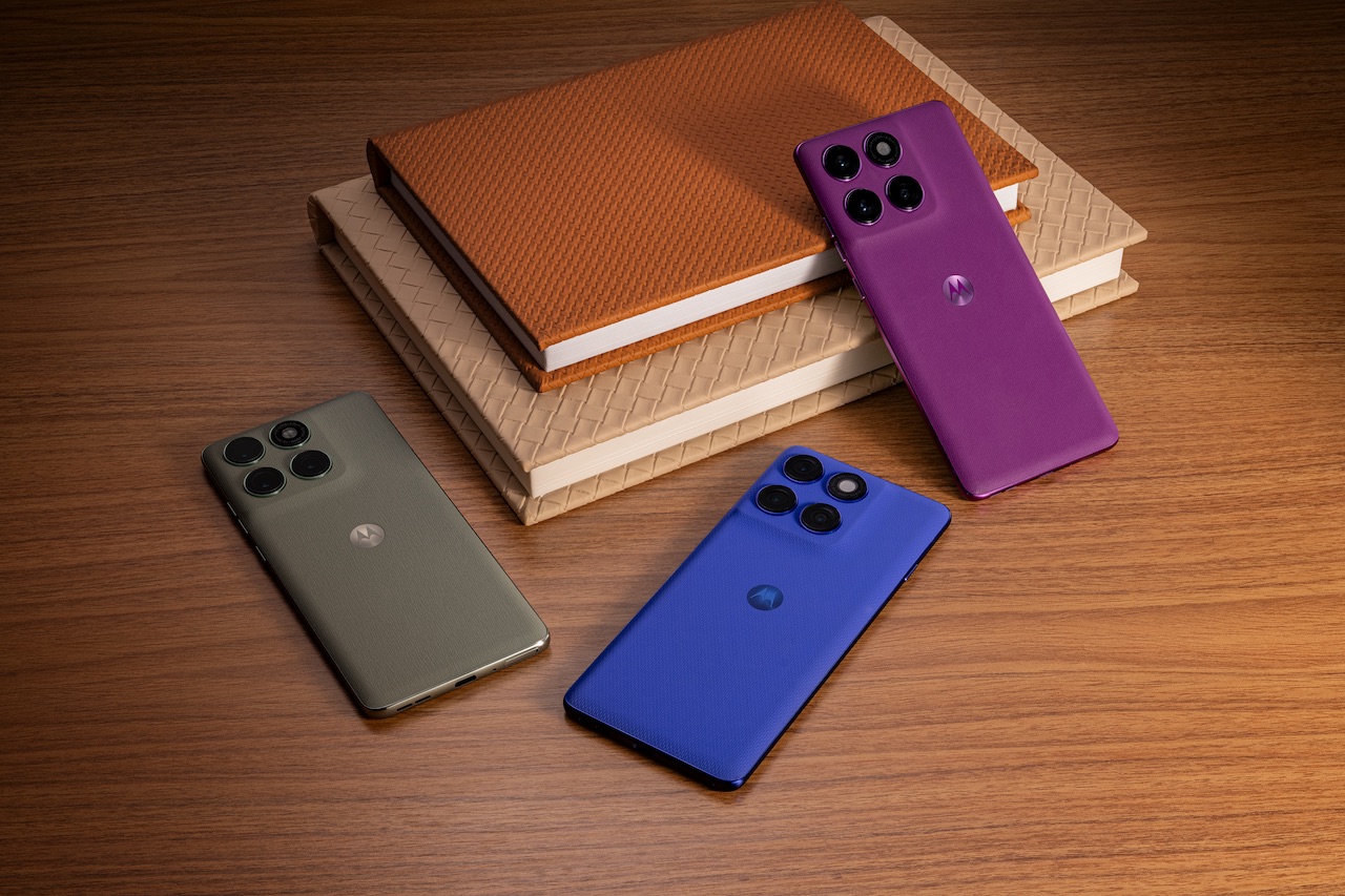 Three colorful Motorola Edge 60 Pro phones resting on a stack of books