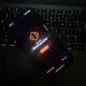 Darkened shot of phone resting on laptop keyboard while displaying Nova Launcher welcome screen