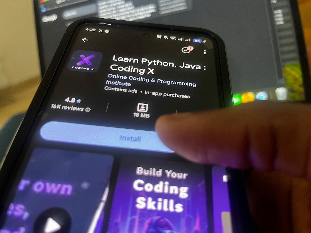Hand hovering over install button on Google Play Store
