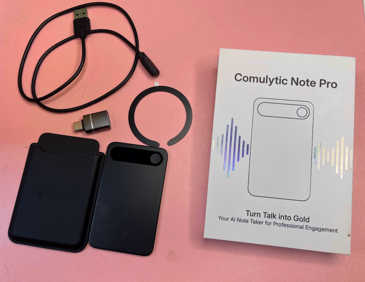 Wallet case and other accessories for Comulytic Note Pro arranged on table