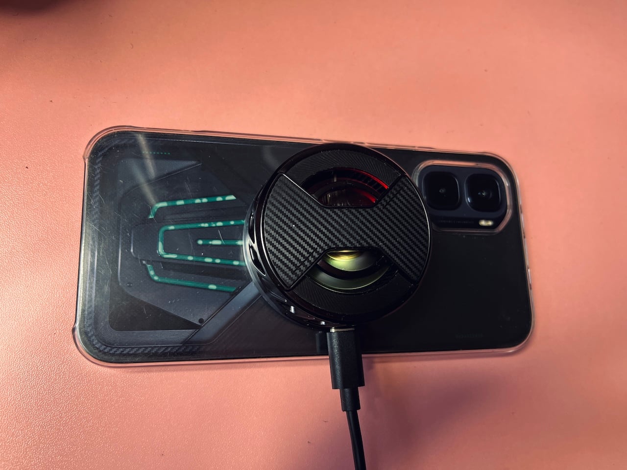 Magnetic cooling charger attached to back of Infinix GT 50 Pro