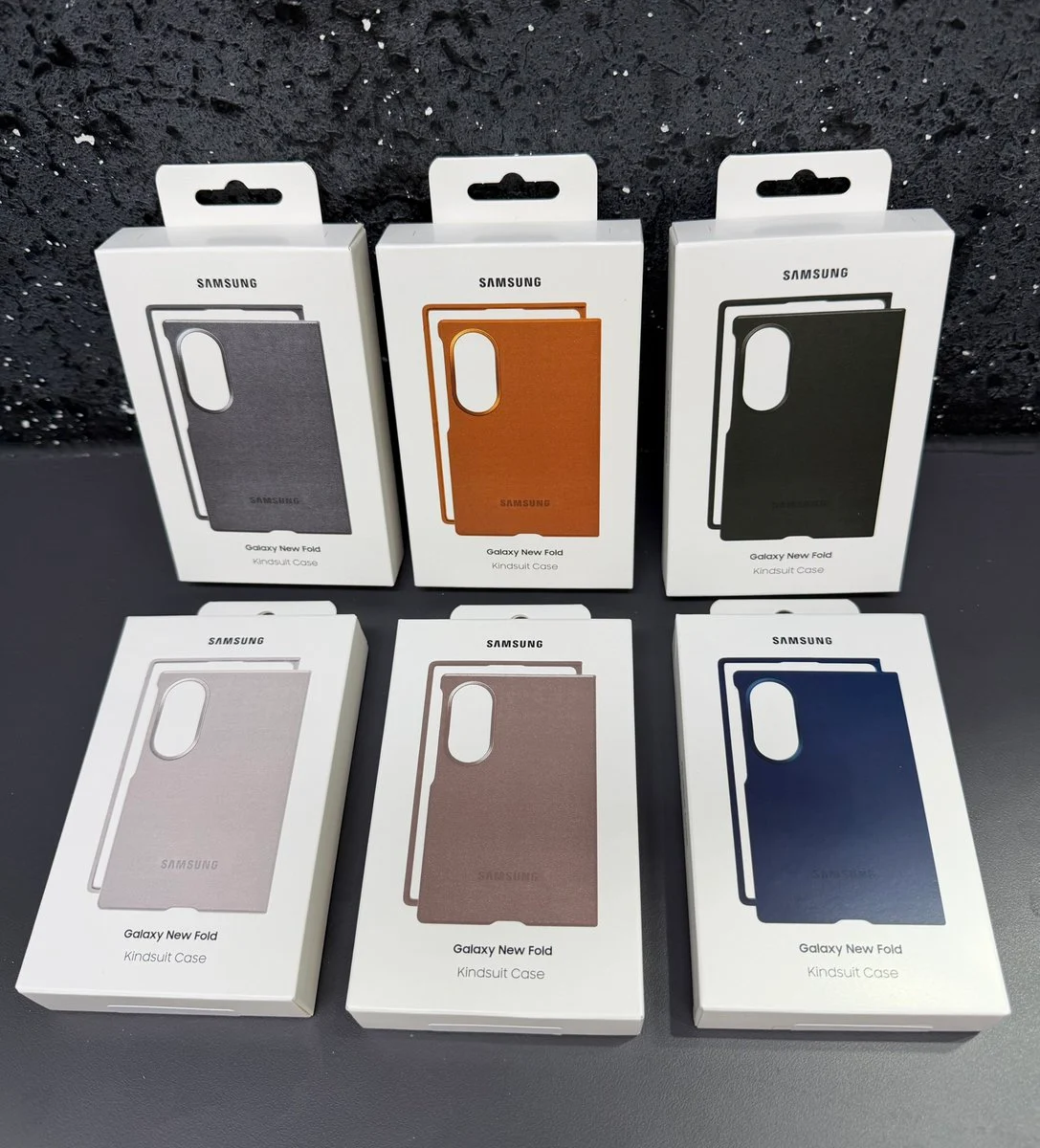 Six packets of Kindsuit cases in different colors