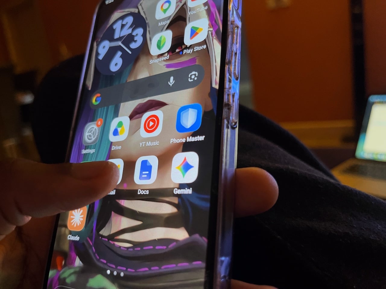 Person holding phone with close-up view of Gemini and Docs apps side-by-side
