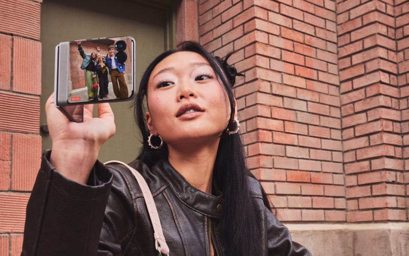 Woman holding foldable Motorola Razr 2026