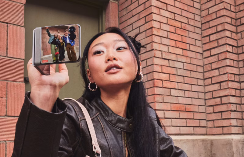 Woman holding foldable Motorola Razr 2026
