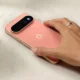 Hand wearing ring resting on Google Pixel 11 Pro back