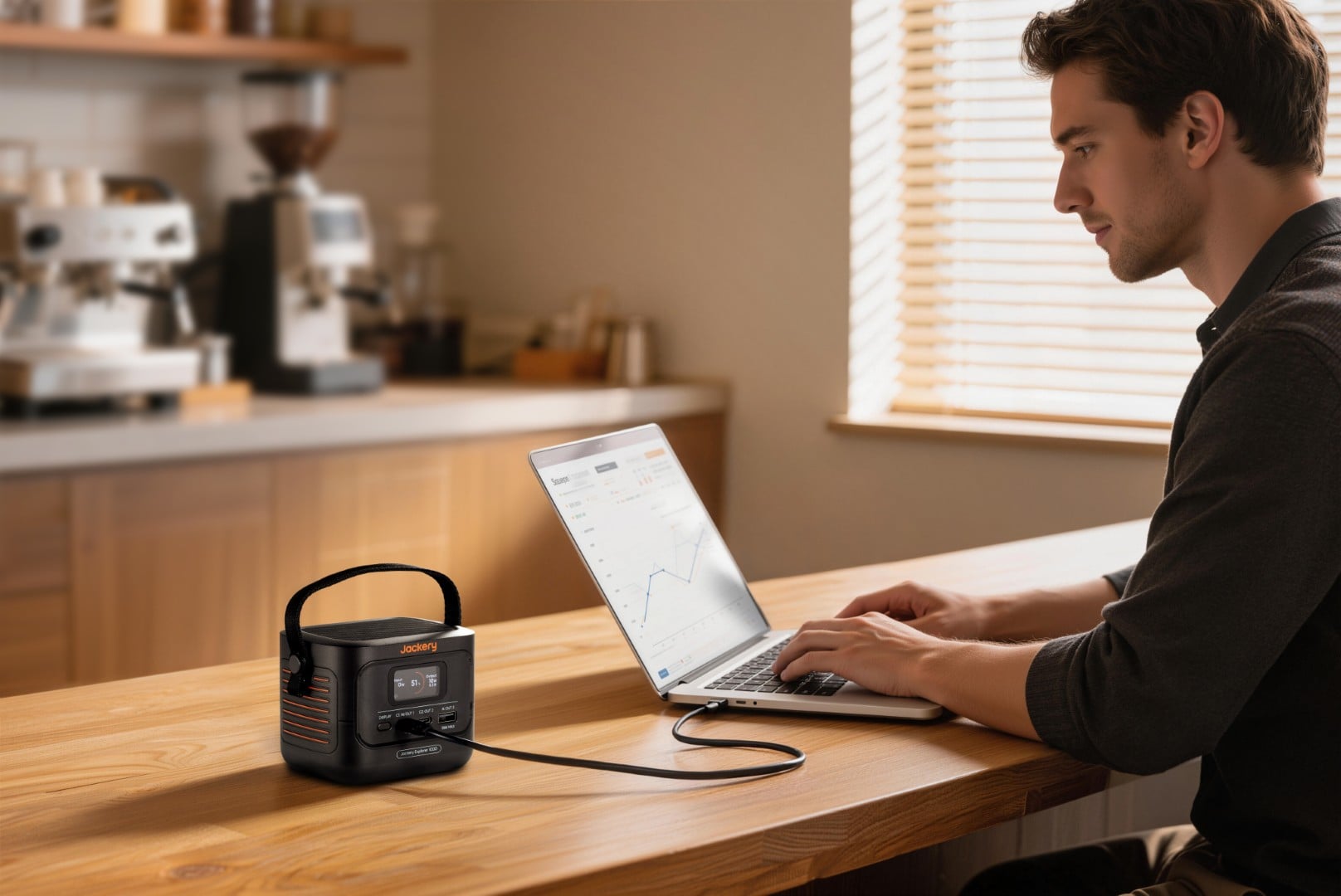 Jackery Explorer 100D powering a laptop on a desk