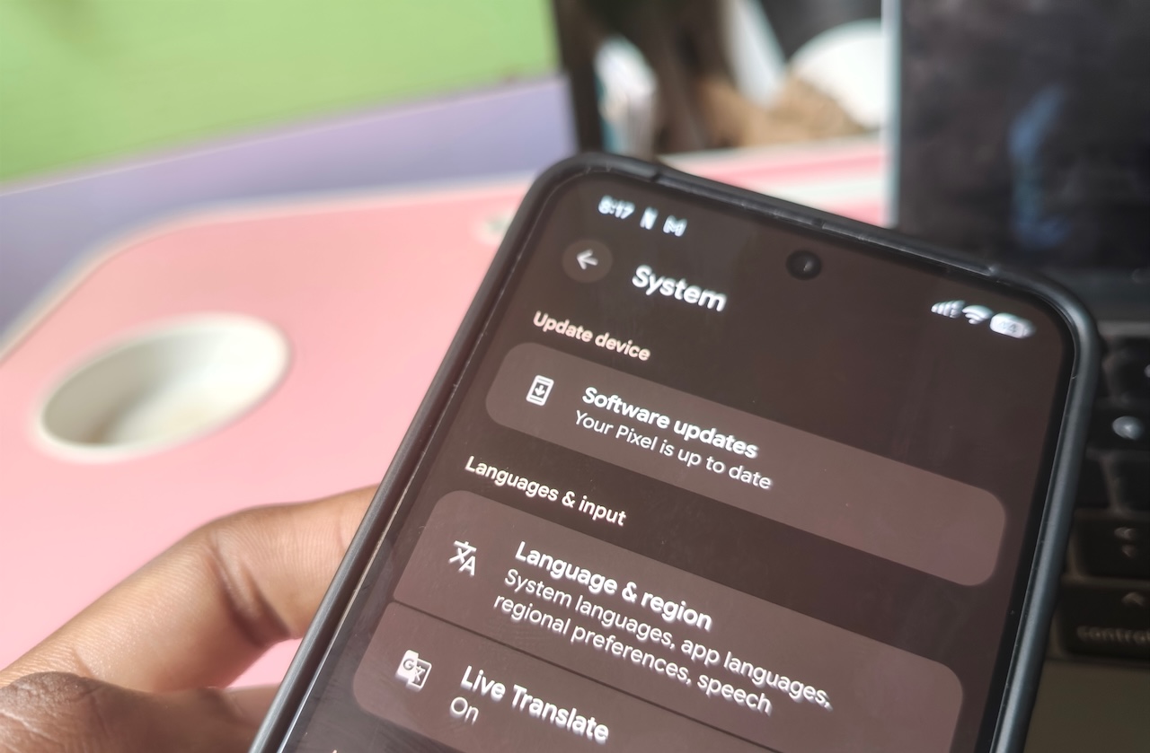 Hand holding Pixel phone with System menu open