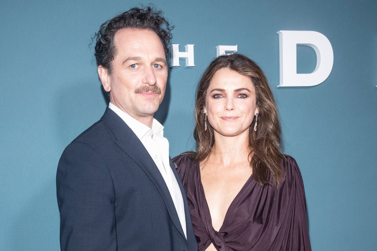Matthew Rhys and Keri Russell posing together at a red carpet event for The Diplomat.