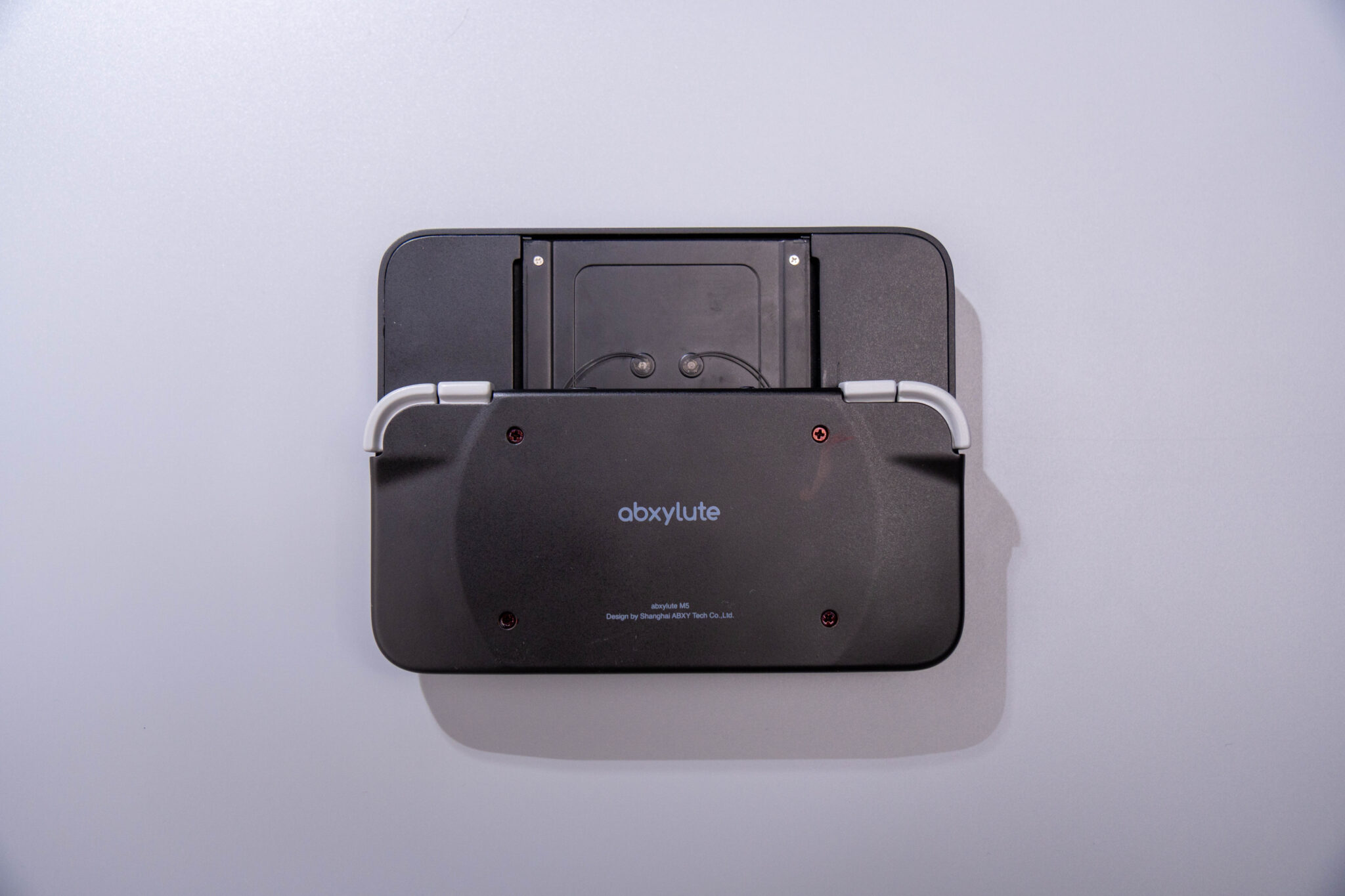 Rear of the Abxylute M6 controller showing the magnetic mount
