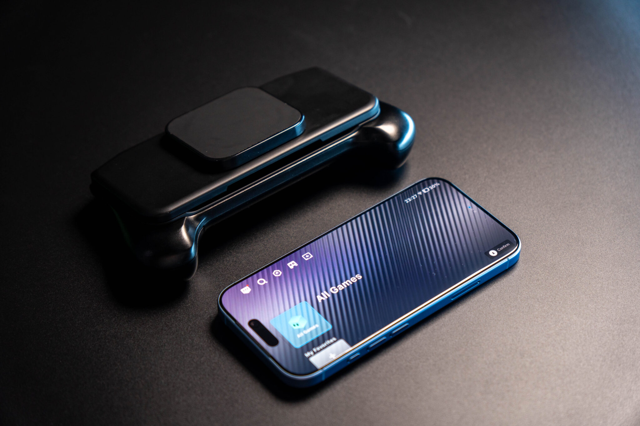 Abxylute M6 mobile controller next to a smartphone