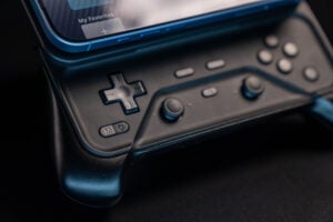 Close-up of the Abxylute M6 controller with a phone attached