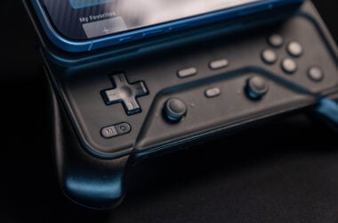 Close-up of the Abxylute M6 controller with a phone attached