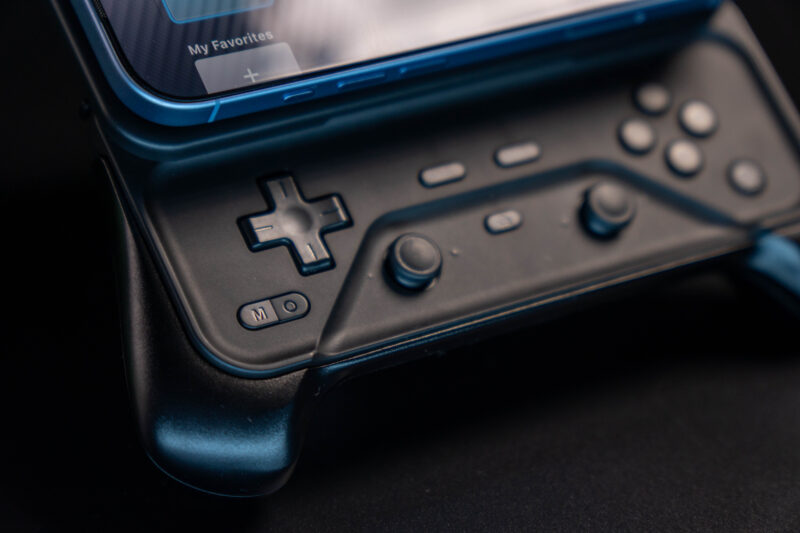 Close-up of the Abxylute M6 controller with a phone attached
